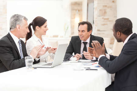 Diverse business group applauding during corporate meeting. Horizontal shot.の写真素材