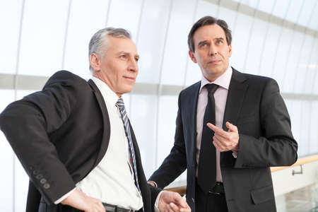 Two mature businessman at officeの写真素材