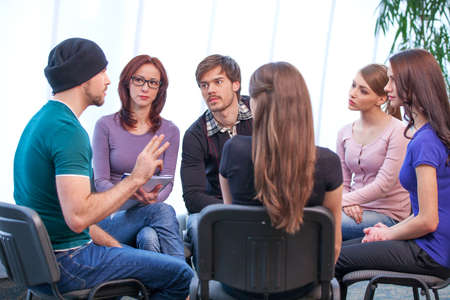 Young man is holding workshop. Discussing several issues and how to solve themの写真素材