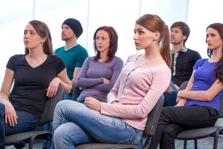 Group of people listening seminar. While sitting in chair, casual outfitの写真素材