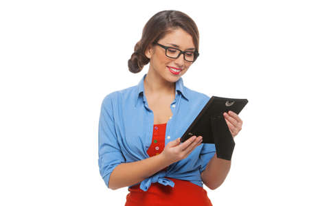 Woman with photo frame. Beautiful young woman in glasses holding photo frame and smiling while isolated on whiteの写真素材