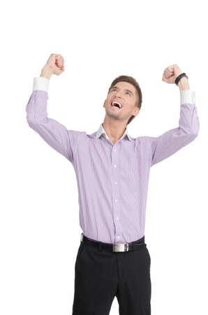 Handsome young man cheers with arms raised into the air  Vertical shot  Isolated on white の写真素材