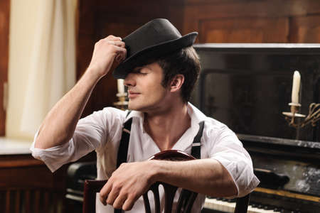 Talented and creative. Portrait of handsome young men sitting in front of his piano with closed eyesの写真素材