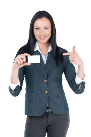 Nice businesswoman showing blank card in her hand. Pointing on it with finger and smilingの写真素材