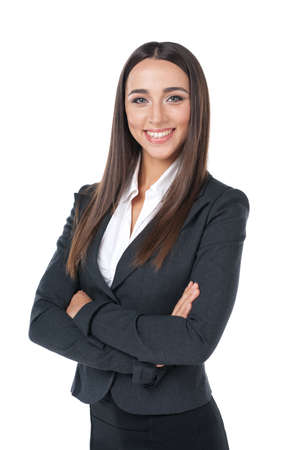 Pleasant businesswoman smiling with hand crossed. Standing isolated on whiteの写真素材