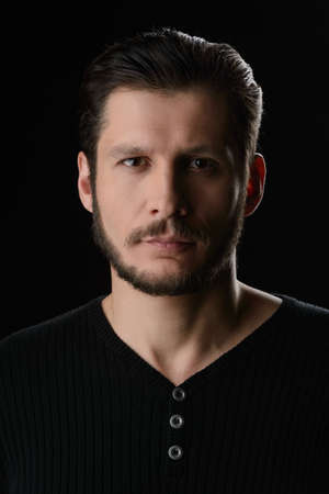 Bearded man. Portrait of bearded man looking at camera while isolated on blackの写真素材