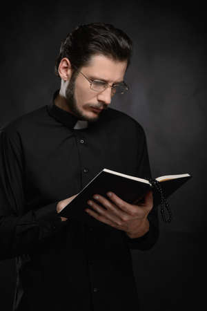 Priest reading the Holy Bible. Portrait of priest reading the Holy Bibleの写真素材