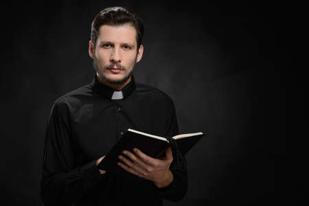 Priest with Holy Bible. Portrait of priest reading the Holy Bibleの写真素材