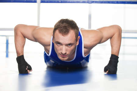 Sportsman pushing up. Young sportsman pushing up and looking awayの写真素材