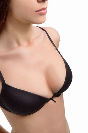 Woman in black bra. Close-up top view of woman in black bra isolated on whiteの写真素材