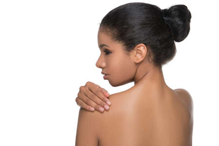Body care. Rear view of beautiful naked women standing back to camera and holding her hand on...
