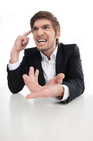Angry businessman. Angry young businessman shouting and gesturing while isolated on whiteの写真素材