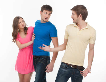 Men conflicting  Two angry men conflicting about girl while standing isolated on whiteの写真素材