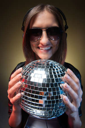 Women with disco ball. Beautiful young women holding disco ball and smiling at cameraの写真素材