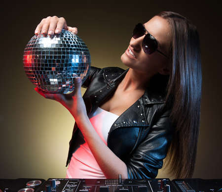 Women with disco ball. Beautiful young women holding disco ball and smilingの写真素材