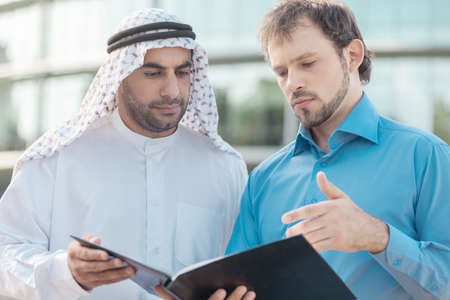 Discussing business plan. Two confident business partners discussing business planの写真素材