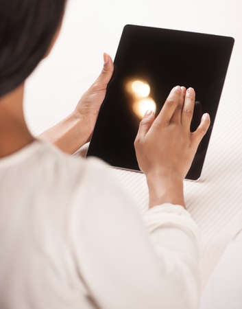 Woman with digital tablet. Top view of beautiful African descent women working on digital tabletの写真素材