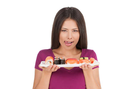 Woman with fresh sushi. Portrait of beautiful mixed race woman holding a plate of sushi while isolated on whiteの写真素材