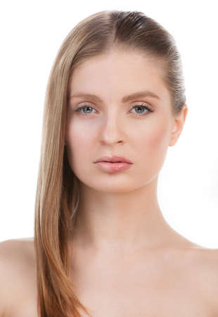 With and without make-up. Portrait of beautiful young woman with make-up on the one part of face and without make-up on another standing isolated on whiteの写真素材