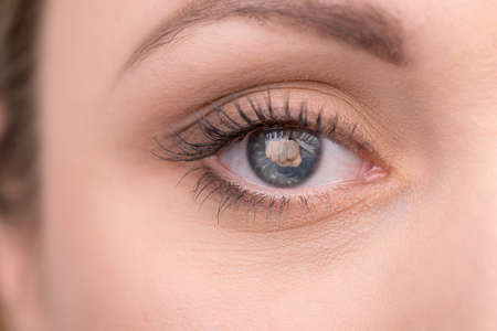 Creative shoot of woman eye with knock reflection. Idea of household crime
