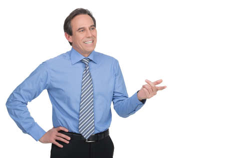 Successful businessman. Handsome mature businessman gesturing while standing isolated on whiteの写真素材