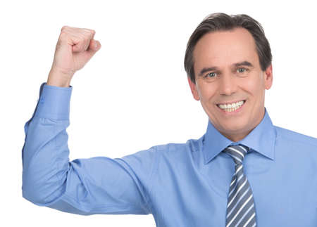 Power and success. Handsome mature businessman gesturing and showing his power while standing isolated on whiteの写真素材