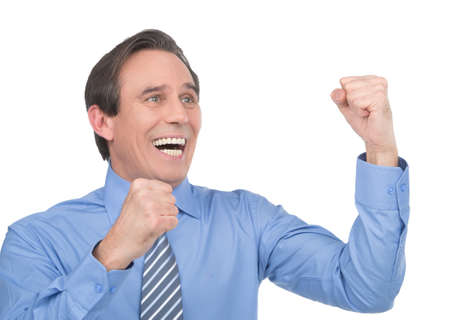 He is everyday winner. Portrait of happy mature businessman standing isolated on whiteの写真素材