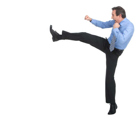 Strength and authority. Full length of angry businessman imitating a fight standing against white backgroundの写真素材