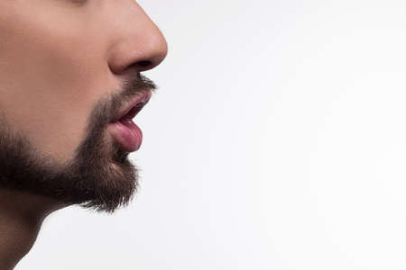 Whispering . Man whispering to gossip isolated on a white background.の写真素材