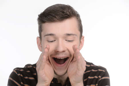 Men shouting. Cheerful young men shouting and holding his hands near mouth while isolated on white