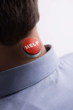 Help! Close-up rear view of men with a help button on his neck standing isolated on white