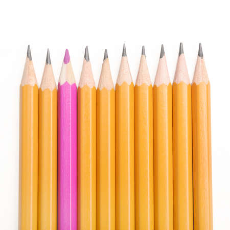 Pencils in a row, with one inverted, to symbolize individualityの写真素材