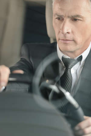 Senior businessmen driving a car  Confident senior businessman driving a carの写真素材