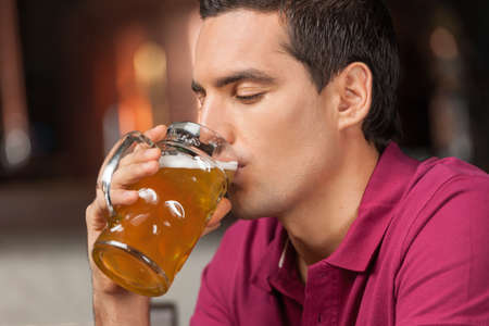 Good beer. Portrait of handsome young men drinking beer at the pub