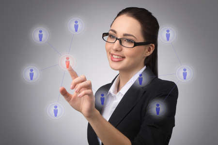 businesswoman managing her contact network, pressing hi-tech buttonsの写真素材