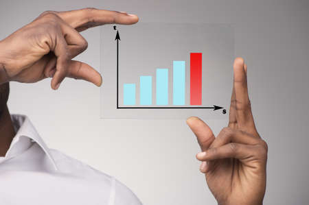 Businessman holding transparency sheet with diagram. (Focus On Foreground)の写真素材