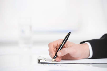 Business notes. Close-up of hand writing something in a note padの写真素材