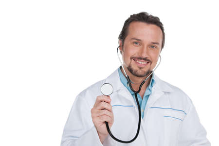 Portrait of Smiling doctor showing stethoscope on camera. Standing isolated on whiteの写真素材