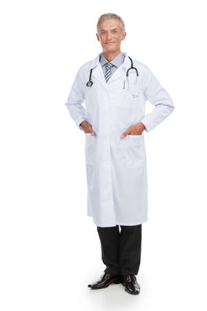 Adult nice looking doctor looking at camera. Standing isolated on white backgroundの写真素材