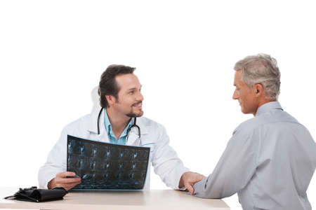 Trustful doctor say good news to old patient. Sitting isolated on whiteの写真素材