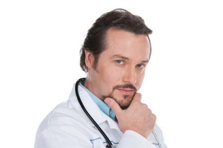 Portrait of adult doctor. Isolated on white, looking at camera, having smart and confident look.の写真素材