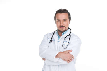 Confident adult doctor standing on white background. Having thoughtful and smart lookの写真素材