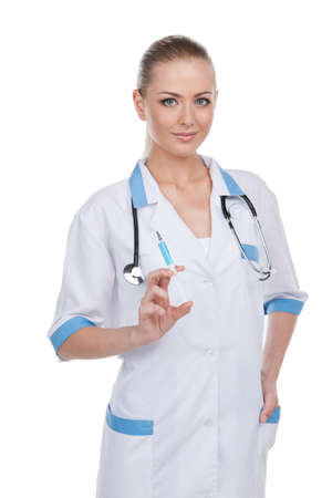 Attractive young nurse with syringe. Standing isolated on white backgroundの写真素材