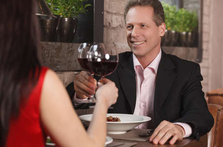 Spending their time together at the restaurant. Mature couple drinking wine at the restaurantの写真素材