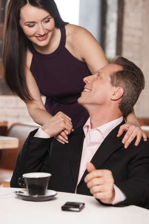 So nice to meet you! Happy mature couple looking at each other and holding hands at the restaurantの写真素材