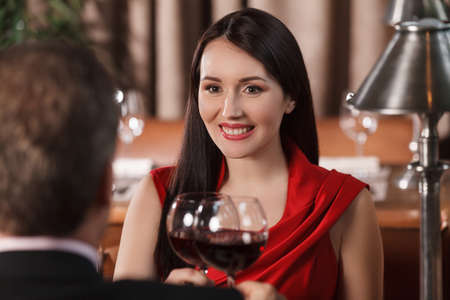Their special date. Beautiful mature couple drinking wine at restaurant and looking at each otherの写真素材
