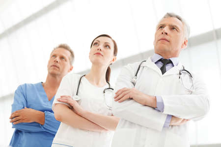 Successful medical team. Successful doctors team standing together with their arms crossedの写真素材