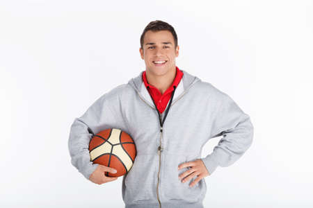 Basketball trainer. Smiling coach with basketballの写真素材