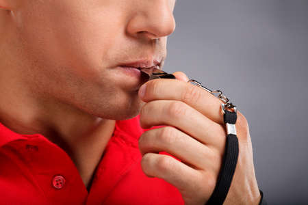 Whistle. Man blowing a whistleの写真素材