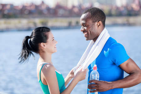 Sport is life. Young interracial couple relaxing after the outdoot trainingの写真素材